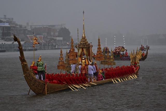 Oarsmen row barges in the rain along the Chao Phraya River during the full dress rehearsal for the Royal Barge Procession in honour of Thailand's Queen Suthida in Bangkok on October 28, 2026. (Photo by Lillian SUWANRUMPHA / AFP)