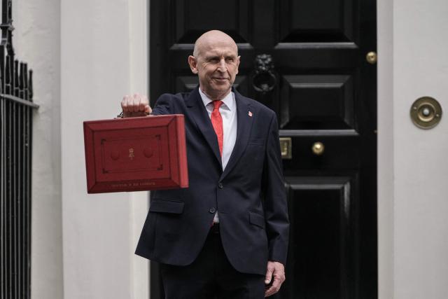 Britain's Chancellor of the Exchequer John Healey poses with the Budget Box as he leaves 11 Downing Street in central London on October 28, 2026, before presenting the government's annual budget to parliament. Healey will unveil his first budget on October 28 as he juggles commitments to defence spending and easing household bills with little financial room to manoeuvre. (Photo by CARLOS JASSO / AFP)