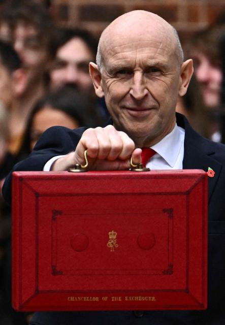 Britain's Chancellor of the Exchequer John Healey poses with the Budget Box as he leaves 11 Downing Street in central London on October 28, 2026, before presenting the government's annual budget to Parliament. On Wednesday, John Healey will present his first budget, which will test its ability to support purchasing power and increase defence spending, all while working with limited financial leeway. (Photo by Dylan Martinez / POOL / AFP)