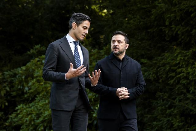 Dutch Prime Minister Rob Jetten (L) walks in the gardens with Ukraine's President Volodymyr Zelensky (R) ahead of bilateral talks focused on air defense and economic partnership at the Catshuis in The Hague on October 28, 2026. (Photo by Remko de Waal / ANP / AFP) / Netherlands OUT