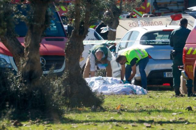 Civil guards stand near victims the site of a train crash between a high speed Renfe AVE train and Iryo train around 150kms south of Madrid between Urda and Los Yebenes in the province of Toledo, on October 28, 2026. A high-speed train collision south of Madrid killed 64 people and injured scores more on Wednesday, with the toll likely to rise, authorities said in Spain's second such disaster this year. (Photo by Oscar DEL POZO / AFP)
