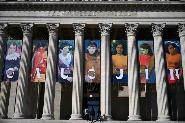 Copies of Gauguin's work are seen as an advertisement on the facade of the museum building to promote an exhibition titled "Bonjour Monsieur Gauguin – The Circles of Post-Impressionists and Symbolists" at the Museum of Fine Arts in Budapest on October 28, 2026. The first major Hungarian exhibition dedicated to French painter Paul Gauguin features 80 of his works, alongside masterpieces by artists such as Gustave Courbet, Camille Pissarro, Claude Monet, Paul Cezanne, Vincent van Gogh, Emile Bernard, and Paul Serusier. The exhibition was realized through the collaboration of Budapest's museum and over 40 lending institutions, including the Musйe d’Orsay in Paris, the Metropolitan Museum of Art and the Museum of Modern Art (MoMA) in New York, the National Gallery of Art in Washington, the Van Gogh Museum in Amsterdam, the Tate in London, and the Museo Nacional Thyssen-Bornemisza in Madrid. The exhibition officially opens on October 30 and will be running until February 28, 2027. (Photo by Attila KISBENEDEK / AFP)