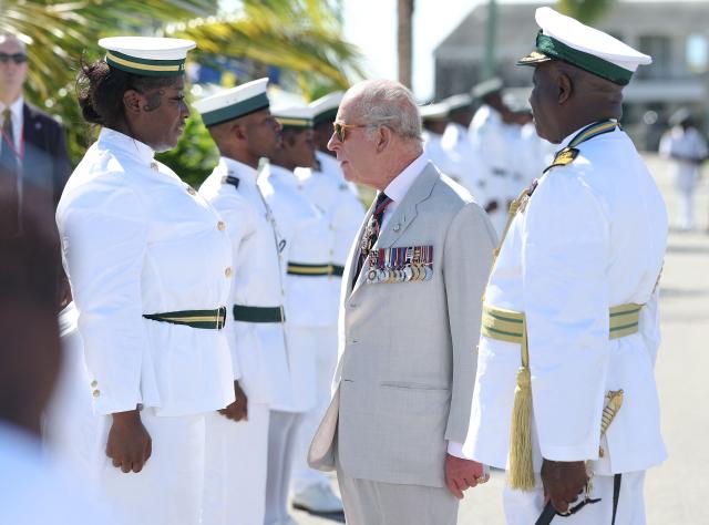 Britain's King Charles III speaks with a member of the Royal Bahamas Defence Force during a visit to Coral Harbour Base in Nassau, Bahamas, on October 28, 2026. King Charles III's Autumn Tour includes visits to The Bahamas, Guyana and Antigua and Barbuda. (Photo by Chris Jackson / POOL / AFP)