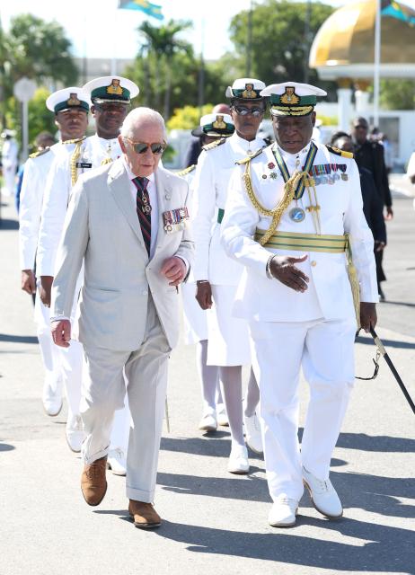 Britain's King Charles III walks with Commander of the Royal Bahamas Defence Force Commodore Floyd Moxey (R) during a visit to Coral Harbour Base in Nassau, Bahamas, on October 28, 2026. King Charles III's Autumn Tour includes visits to The Bahamas, Guyana and Antigua and Barbuda. (Photo by Chris Jackson / POOL / AFP)