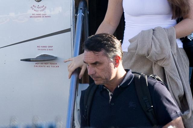 Flavio Bolsonaro steps off a plane after arriving at Opa Locka Executive Airport in Miami, Florida on October 28, 2026. Brazil's defeated right-wing presidential candidate Flavio Bolsonaro stepped out of a private plane in Florida today, AFP witnessed, despite a court order banning him from leaving his country. His plane touched down at Opa-Locka Executive Airport outside Miami after flying from Argentina with a stopover in Ecuador, as speculation had swirled for days over his whereabouts. (Photo by Ricardo ARDUENGO / AFP)