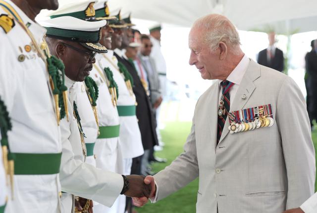 Britain's King Charles III greets members of the Royal Bahamas Defence Force during his visit to Coral Harbour Base in Nassau, Bahamas, on October 28, 2026. King Charles III's Autumn Tour includes visits to The Bahamas, Guyana and Antigua and Barbuda. (Photo by Chris Jackson / POOL / AFP)