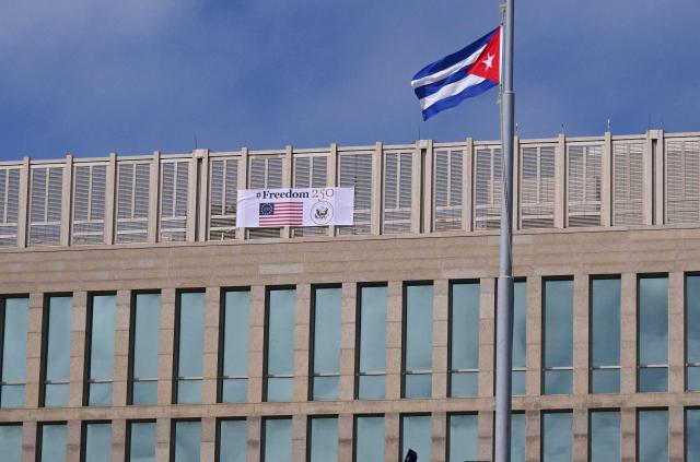 A Cuban flag is pictured in front of the US Embassy building with a banner reading “Freedom 250” to mark the July 4th celebrations of the 250th anniversary of US independence in Havana on October 28, 2026. (Photo by YAMIL LAGE / AFP)
