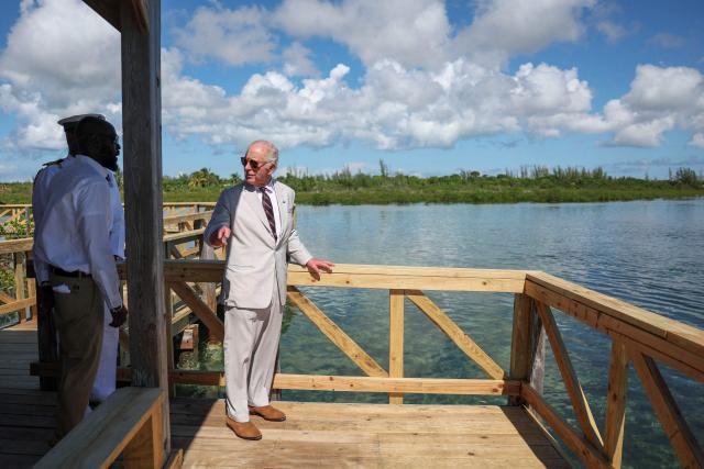 Britain's King Charles III speaks with Anwar Rolle, New Providence (NP) Parks Manager, during a visit of the mangrove ecosystem at Bonefish Pond National Park in New Providence, Nassau, The Bahamas on October 28, 2026. King Charles III's Autumn Tour includes visits to The Bahamas, Guyana and Antigua and Barbuda. (Photo by Isabel Infantes / POOL / AFP)