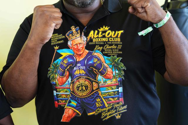 A member of staff wears a depiction of Britain's King Charles III during a visit by the King to The Bahamas Boxing Academy in Nassau, The Bahamas, on October 28, 2026. King Charles III's Autumn Tour includes visits to The Bahamas, Guyana and Antigua and Barbuda. (Photo by Aaron Chown / POOL / AFP)