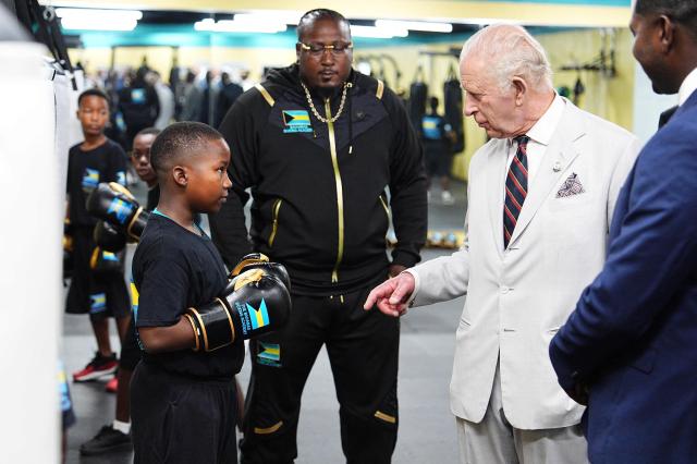 Britain's King Charles III meets young boxers during a visit to The Bahamas Boxing Academy in Nassau, The Bahamas, on October 28, 2026. King Charles III's Autumn Tour includes visits to The Bahamas, Guyana and Antigua and Barbuda. (Photo by Aaron Chown / POOL / AFP)