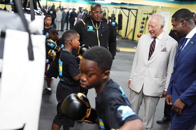 Britain's King Charles III meets young boxers during a visit to The Bahamas Boxing Academy in Nassau, The Bahamas, on October 28, 2026. King Charles III's Autumn Tour includes visits to The Bahamas, Guyana and Antigua and Barbuda. (Photo by Aaron Chown / POOL / AFP)