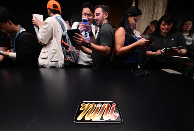 Attendees look at the new OLED iPad Mini during the Apple Experience LA event in Los Angeles, on October 28, 2026. (Photo by Frederic J. Brown / AFP)