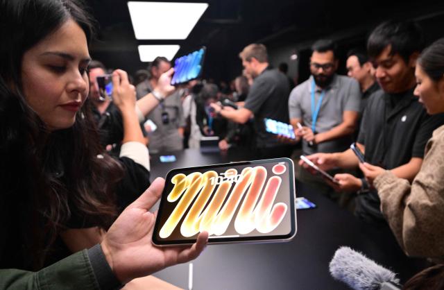 Attendees look at the new OLED iPad Mini during the Apple Experience LA event in Los Angeles, on October 28, 2026. (Photo by Frederic J. Brown / AFP)