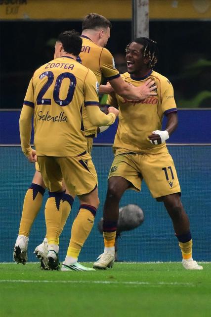 Bologna’s Belgian forward #11 Samuel Mbangula (R) with teammates celebrates after scoring his second goal during the Italian Serie A football match between AC Milan and Bologna at the San Siro stadium in Milan, northern Italy on October 28, 2026. (Photo by Marco Bertorello / AFP)