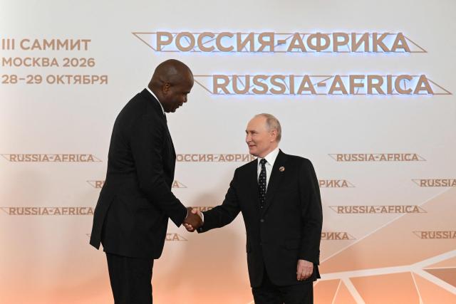Russian President Vladimir Putin greets Mozambique’s President Daniel Chapo during a welcoming ceremony for participants of the Russia-Africa summit at the Grand Kremlin Palace in central Moscow on October 28, 2026. (Photo by Igor IVANKO / POOL / AFP)