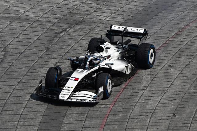 Cadillac F1 Team Mexican driver Sergio Perez waves during an exhibition at Reforma avenue ahead of the Mexican Formula 1 Grand Prix in Mexico City on October 28, 2026. (Photo by Alfredo ESTRELLA / AFP)