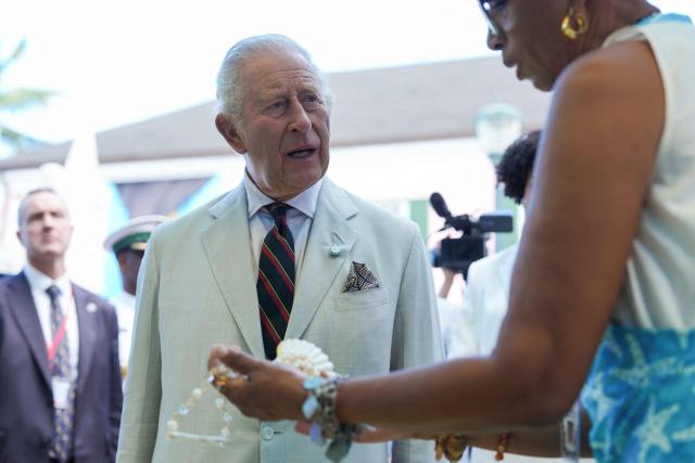 Britain's King Charles III speaks with a local store owner in Parliament Square in Nassau, The Bahamas on October 28, 2026. King Charles III's Autumn Tour includes visits to The Bahamas, Guyana and Antigua and Barbuda. (Photo by Ben Stansall / POOL / AFP)