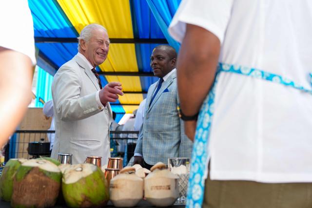 Britain's King Charles III speaks with local store owners in Parliament Square in Nassau, The Bahamas on October 28, 2026. King Charles III's Autumn Tour includes visits to The Bahamas, Guyana and Antigua and Barbuda. (Photo by Ben Stansall / POOL / AFP)