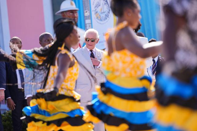 Dancers perform as Britain's King Charles III watches a Junkanoo parade in Parliament Square in Nassau, The Bahamas on October 28, 2026. King Charles III's Autumn Tour includes visits to The Bahamas, Guyana and Antigua and Barbuda. (Photo by Ben Stansall / POOL / AFP)