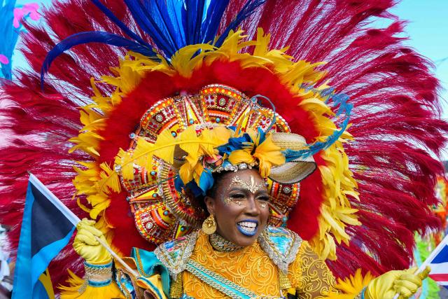 Participants march in a Junkanoo parade as Britain's King Charles III visits in Parliament Square in Nassau, The Bahamas on October 28, 2026. King Charles III's Autumn Tour includes visits to The Bahamas, Guyana and Antigua and Barbuda. (Photo by Ben Stansall / POOL / AFP)