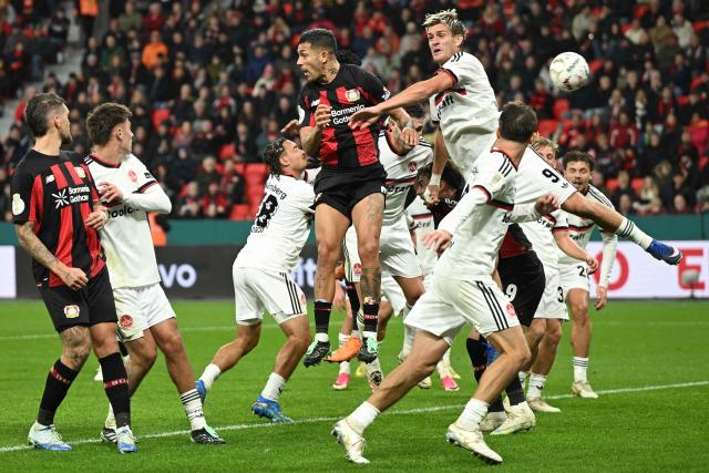 Players vie in the box as Bayer Leverkusen's Burkinabe defender #12 Edmond Tapsoba (hidden) scores the 1-2 goal during the German Cup (DFB-Pokal) football match between Bayer 04 Leverkusen and FC Nuernberg in Leverkusen, western Germany on October 28, 2026. (Photo by INA FASSBENDER / AFP) / DFB REGULATIONS PROHIBIT ANY USE OF PHOTOGRAPHS AS IMAGE SEQUENCES AND QUASI-VIDEO.