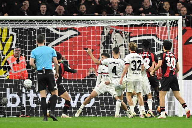 Bayer Leverkusen's Burkinabe defender #12 Edmond Tapsoba (2nd L) scores the 2-2 goal during the German Cup (DFB-Pokal) football match between Bayer 04 Leverkusen and FC Nuernberg in Leverkusen, western Germany on October 28, 2026. (Photo by INA FASSBENDER / AFP) / DFB REGULATIONS PROHIBIT ANY USE OF PHOTOGRAPHS AS IMAGE SEQUENCES AND QUASI-VIDEO.