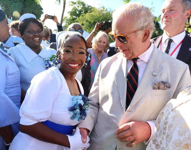 Britain's King Charles III shakes shakes hands with representatives of community and voluntary organisations during a garden party in Parliament Square in Nassau, The Bahamas, on October 28, 2026. King Charles III's Autumn Tour includes visits to The Bahamas, Guyana and Antigua and Barbuda. (Photo by Chris Jackson / POOL / AFP)