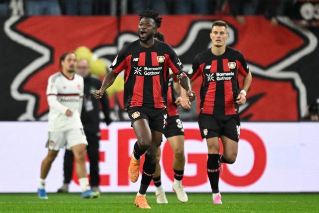 Bayer Leverkusen's Burkinabe defender #12 Edmond Tapsoba celebrates scoring the 2-2 goal with his teammates during the German Cup (DFB-Pokal) football match between Bayer 04 Leverkusen and FC Nuernberg in Leverkusen, western Germany on October 28, 2026. (Photo by INA FASSBENDER / AFP) / DFB REGULATIONS PROHIBIT ANY USE OF PHOTOGRAPHS AS IMAGE SEQUENCES AND QUASI-VIDEO.