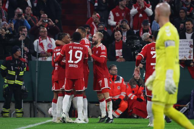 Bayern Munich's French forward #17 Michael Olise (L) celebrates with team mates after scoring the 3-1 penalty goal as Magdeburg's German goalkeeper #01 Dominik Reimann (R) reacts during the German Cup (DFB-Pokal) football match between FC Bayern Munich and 1. FC Magdeburg in Munich, southern Germany on October 28, 2026. (Photo by Karl-Josef HILDENBRAND / AFP) / DFB REGULATIONS PROHIBIT ANY USE OF PHOTOGRAPHS AS IMAGE SEQUENCES AND QUASI-VIDEO.