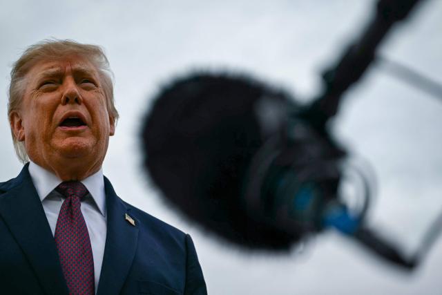 US President Donald Trump speaks with reporters before boarding Air Force One at Joint Base Andrews, Maryland, on October 28, 2026. President Trump is travelling to Ohio to speak at a midterm campaign rally. (Photo by Kent NISHIMURA / AFP)