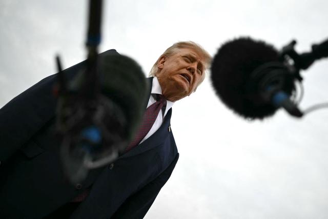 US President Donald Trump speaks with reporters before boarding Air Force One at Joint Base Andrews, Maryland, on October 28, 2026. President Trump is travelling to Ohio to speak at a midterm campaign rally. (Photo by Kent NISHIMURA / AFP)