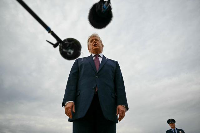 US President Donald Trump speaks with reporters before boarding Air Force One at Joint Base Andrews, Maryland, on October 28, 2026. President Trump is travelling to Ohio to speak at a midterm campaign rally. (Photo by Kent NISHIMURA / AFP)