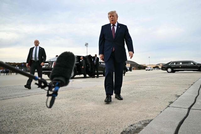US President Donald Trump approaches to speak with reporters before boarding Air Force One at Joint Base Andrews, Maryland, on October 28, 2026. President Trump is travelling to Ohio to speak at a midterm campaign rally. (Photo by Kent NISHIMURA / AFP)