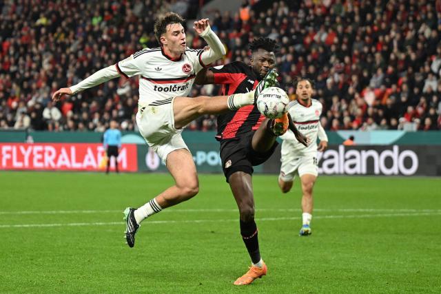 Nuremberg's Spanish midfielder #08 Javier Fernandez (L) and Bayer Leverkusen's Burkinabe defender #12 Edmond Tapsoba vie for the ball during the German Cup (DFB-Pokal) football match between Bayer 04 Leverkusen and FC Nuernberg in Leverkusen, western Germany on October 28, 2026. (Photo by INA FASSBENDER / AFP) / DFB REGULATIONS PROHIBIT ANY USE OF PHOTOGRAPHS AS IMAGE SEQUENCES AND QUASI-VIDEO.