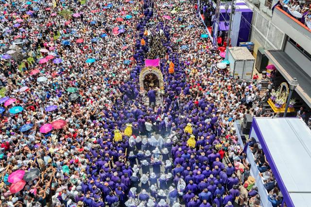 This aerial view shows devotees taking part in a procession honouring Senor de los Milagros (Lord of Miracles) in Lima, Peru, on October 28, 2026. (Photo by Connie FRANCE / AFP)