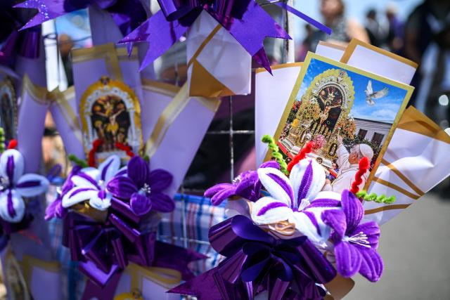 A vendor sells souvenirs featuring Pope Leo XIV and Senor de los Milagros (Lord of Miracles) during a procession honouring Senor de los Milagros in Lima on October 28, 2026. (Photo by Connie FRANCE / AFP)