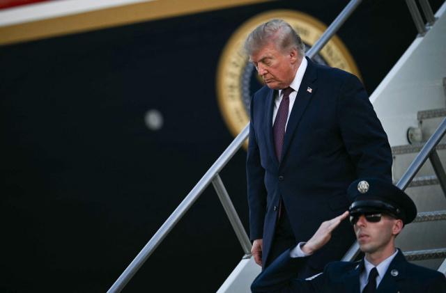 US President Donald Trump disembarks from Air Force One at Rickenbacker International Airport in Columbus, Ohio on October 28, 2026. President Trump is travelling to Ohio to speak at a midterm campaign rally. (Photo by Kent NISHIMURA / AFP)