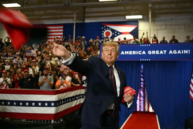 US President Donald Trump throws MAGA hats to the crowd upon arrival to speak at a midterm campaign rally at Shoemaker Center in Chillicothe, Ohio, on October 28, 2026. (Photo by Kent NISHIMURA / AFP)