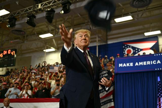 US President Donald Trump throws MAGA hats to the crowd upon arrival to speak at a midterm campaign rally at Shoemaker Center in Chillicothe, Ohio, on October 28, 2026. (Photo by Kent NISHIMURA / AFP)