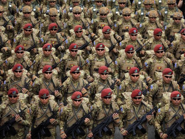 (FILES) Members of the Salvadoran military parade during celebrations marking the 205th anniversary of El Salvador's independence, in San Salvador on September 15, 2026. El Salvador deployed a contingent of more than 2,000 troops to Haiti for an operation to rescue four Salvadoran soldiers who went missing ten days ago following an ambush by armed gangs, the government said on October 28, 2026. (Photo by MARVIN RECINOS / AFP)