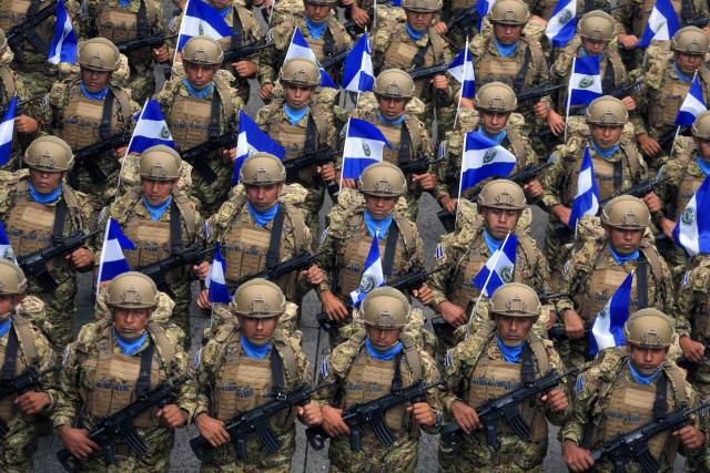 (FILES) Members of the Salvadoran military parade during celebrations marking the 205th anniversary of El Salvador’s independence, in San Salvador on September 15, 2026. El Salvador deployed a contingent of more than 2,000 troops to Haiti for an operation to rescue four Salvadoran soldiers who went missing ten days ago following an ambush by armed gangs, the government said on October 28, 2026. (Photo by MARVIN RECINOS / AFP)