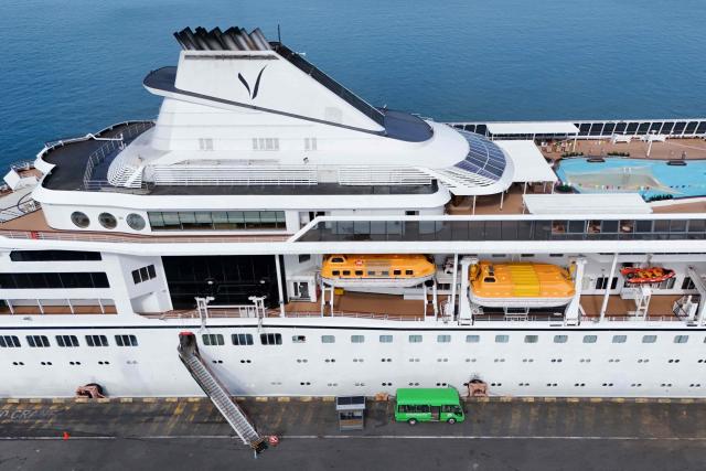 An aerial view shows the Villa Vie Residences' cruise ship Odyssey docked at Sihanoukville port in Preah Sihanouk province on October 29, 2026. Around 200 passengers who paid to live on a cruise ship while travelling the world were abruptly left in a Cambodian port after the company ran out of money, an official said on October 28. (Photo by Suy SE / AFP)