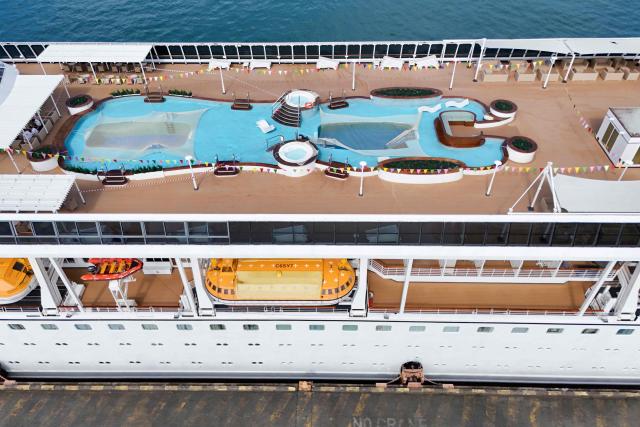 An aerial view shows the Villa Vie Residences' cruise ship Odyssey docked at Sihanoukville port in Preah Sihanouk province on October 29, 2026. Around 200 passengers who paid to live on a cruise ship while travelling the world were abruptly left in a Cambodian port after the company ran out of money, an official said on October 28. (Photo by Suy SE / AFP)