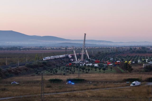 Investigators use heavy machinery to remove damaged carriages of a train crash between two high-speed units, a Renfe AVE train and an Iryo train around 150 km south of Madrid between Urda and Los Yebenes in the province of Toledo, a day after the accident on October 29, 2026. A high-speed train collision south of Madrid killed 68 people and injured scores more, authorities said, in one of Europe's deadliest such disasters this century. The second such accident to strike Spain this year will raise fresh questions about the country's rail safety, with the transport minister speaking of an "error" and "inexplicable circumstances" that led to the crash. (Photo by Oscar DEL POZO / AFP)