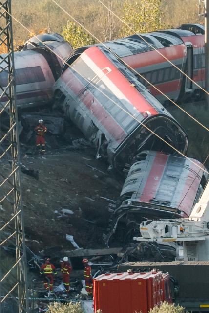 Members of Spain's Emergency Medical Unit (UME) work amongst debris and damaged carriages of a train crash between two high-speed units, a Renfe AVE train and an Iryo train around 150 km south of Madrid between Urda and Los Yebenes in the province of Toledo, a day after the accident on October 29, 2026. A high-speed train collision south of Madrid killed 68 people and injured scores more, authorities said, in one of Europe's deadliest such disasters this century. The second such accident to strike Spain this year will raise fresh questions about the country's rail safety, with the transport minister speaking of an "error" and "inexplicable circumstances" that led to the crash. (Photo by Oscar DEL POZO / AFP)