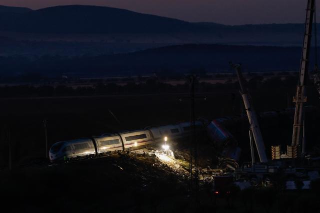 Floodlights illuminate damaged carriages of a train crash between two high-speed units, a Renfe AVE train and an Iryo train around 150 km south of Madrid between Urda and Los Yebenes in the province of Toledo, a day after the accident on October 29, 2026. A high-speed train collision south of Madrid killed 68 people and injured scores more, authorities said, in one of Europe's deadliest such disasters this century. The second such accident to strike Spain this year will raise fresh questions about the country's rail safety, with the transport minister speaking of an "error" and "inexplicable circumstances" that led to the crash. (Photo by Oscar DEL POZO / AFP)