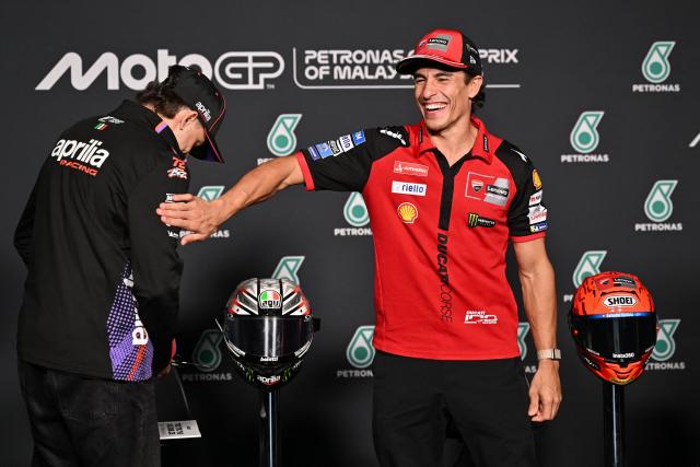 Ducati Lenovo Team's Spanish rider Marc Marquez (R) jokes with Aprilia Racing's Italian rider Marco Bezzecchi (L) after a press conference ahead of the MotoGP Malaysian Grand Prix at the Sepang International Circuit in Sepang on October 29, 2026. (Photo by Mohd Rasfan / AFP)