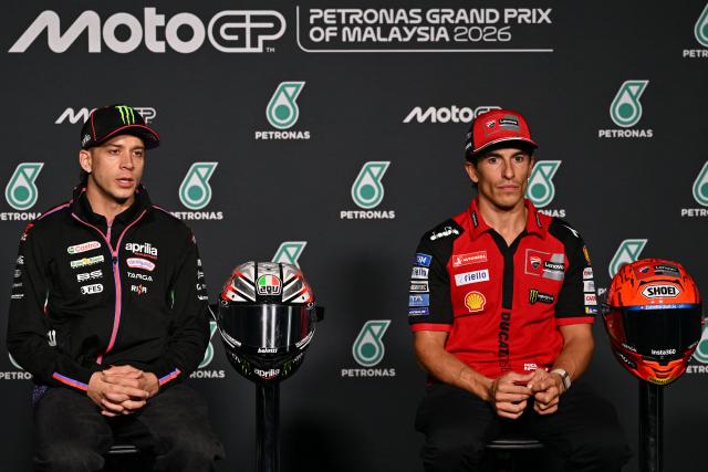 Aprilia Racing's Italian rider Marco Bezzecchi (L) and Ducati Lenovo Team's Spanish rider Marc Marquez attend a press conference ahead of the MotoGP Malaysian Grand Prix at the Sepang International Circuit in Sepang on October 29, 2026. (Photo by Mohd Rasfan / AFP)