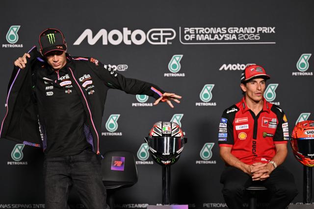 Ducati Lenovo Team's Spanish rider Marc Marquez (R) speaks as  Aprilia Racing's Italian rider Marco Bezzecchi (L) wears a jacket during a press conference ahead of the MotoGP Malaysian Grand Prix at the Sepang International Circuit in Sepang on October 29, 2026. (Photo by Mohd Rasfan / AFP)