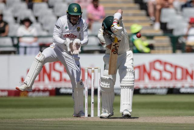 South Africa's Ryan Rickelton (L) attempts to field a ball played by Australia's Josh Inglis (R) on day three of the third Test match between South Africa and Australia at Newlands stadium in Cape Town on October 29, 2026. (Photo by Marco Longari / AFP)